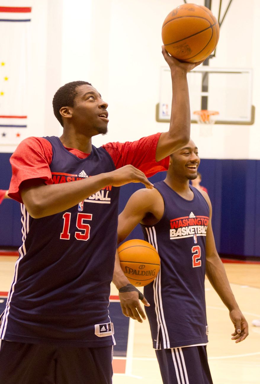 Wizards guards Jordan Crawford (left) opted for more shooting practice after Washington's two preseason losses. John Wall (right) had just six assists to go with 10 turnovers. (Andrew Harnik / The Washington Times)