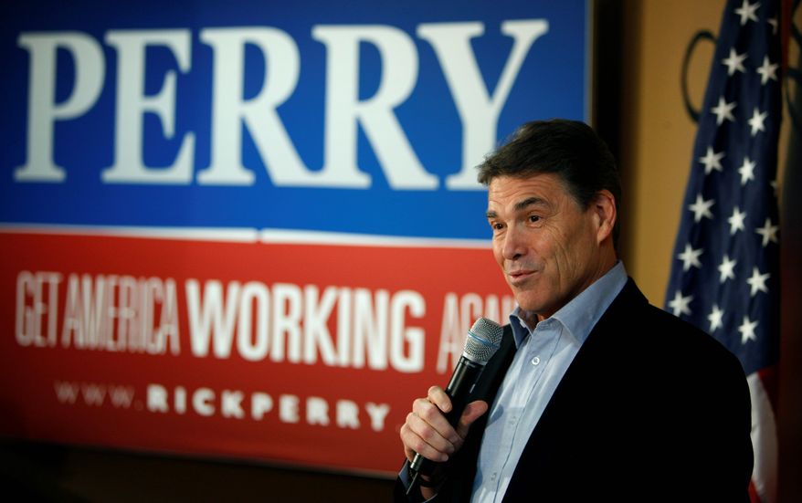 **FILE** Republican presidential hopeful and Texas Gov. Rick Perry speaks Dec. 19, 2011, to local residents during a campaign stop at the Pizza Ranch restaurant in Manchester, Iowa. (Associated Press)