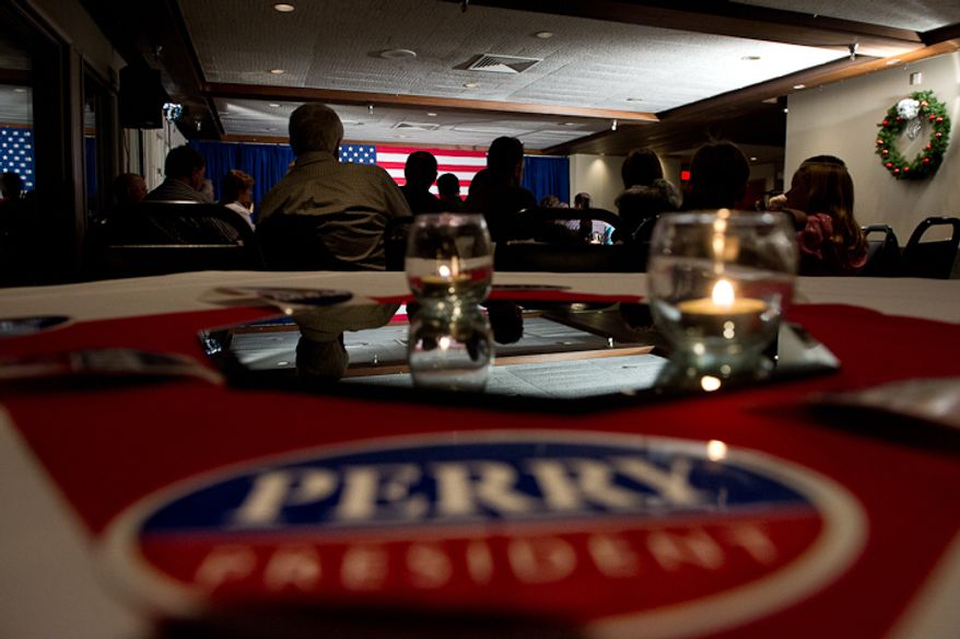 Supporters listen as Republican presidential candidate Rick Perry speaks at a fundraiser held at the Mason City Country Club, Mason City, Iowa, Friday, Dec. 30, 2011. (Andrew Harnik/The Washington Times)