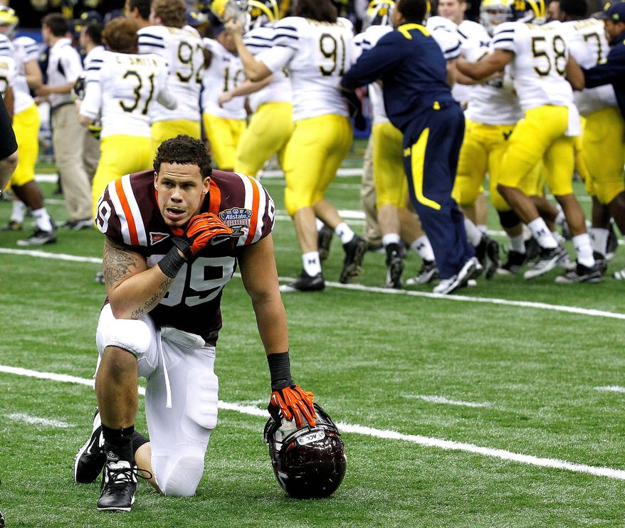 Defensive end James Gayle was left to ponder Virginia Tech's 23-20 overtime loss in the Sugar Bowl as Michigan players celebrated Tuesday night. (Associated Press)