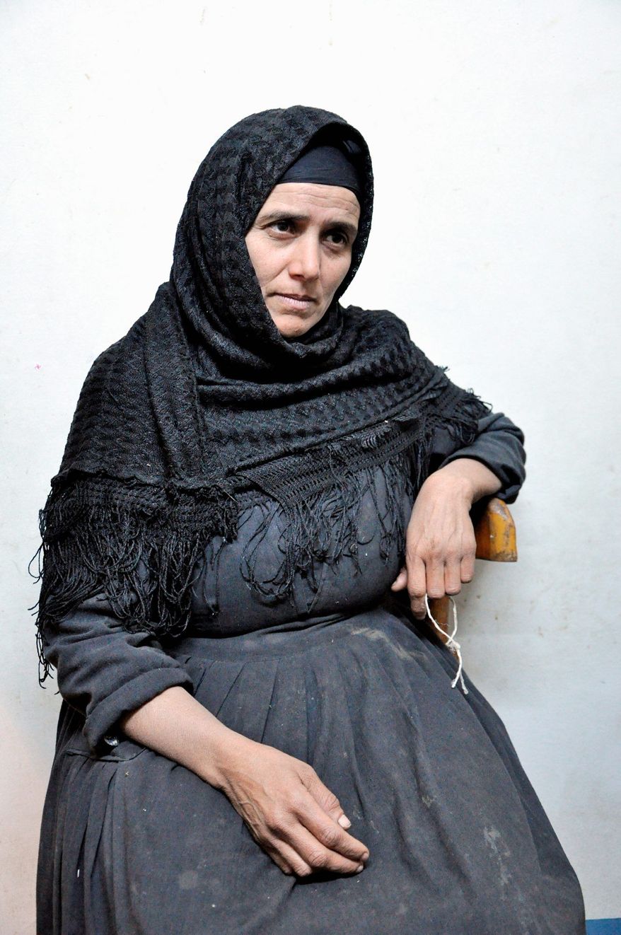 UNDER SIEGE: Mona Hanna says she fears for the future of her town, Abo Korkas, Egypt. She and nine other families fled their homes last year after armed Muslim men set her house afire. (Sarah Lynch/Special to The Washington Times)