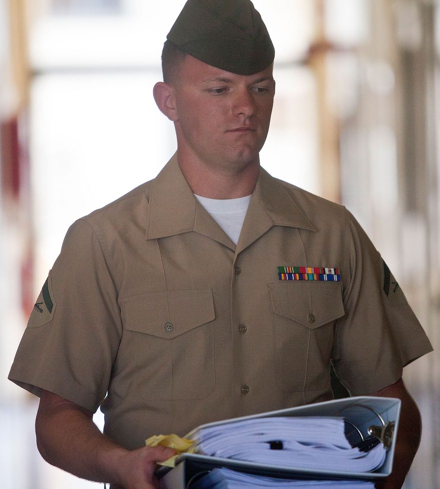 Lance Cpl. Jacob Jacoby enters the courtroom of the Legal Services Center at Marine Corps Base Hawaii on Monday, Jan. 30, 2012, in Kaneohe Bay, Hawaii. (AP Photo/Kent Nishimura)