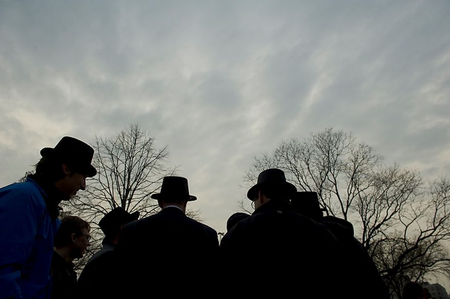 Top-hatted men hosting the inaugural Groundhog Day event at Dupont Circle in Washington on Thursday, Feb. 2, 2012, are silhouetted against a rainy morning sky. (Rod Lamkey Jr./The Washington Times)
