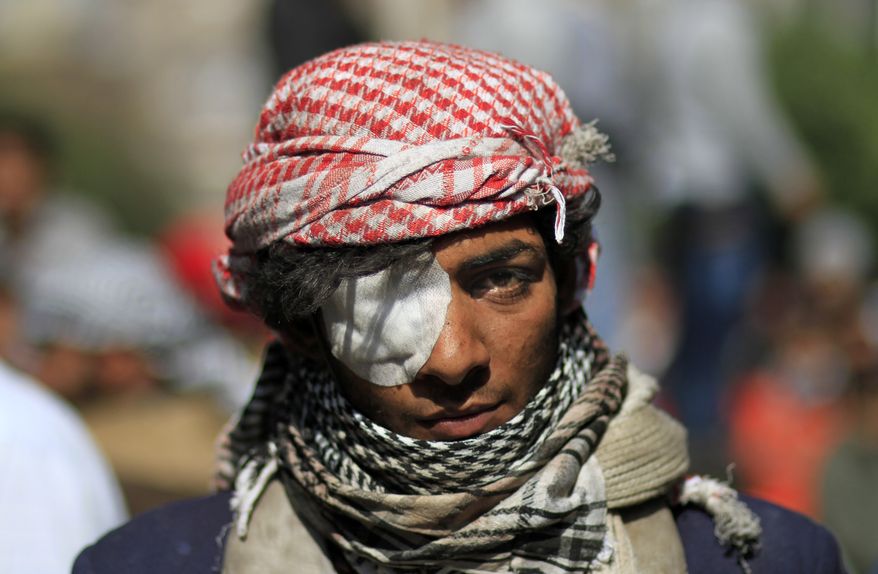 An Egyptian protester looks on during clashes with security forces near the Interior Ministry in Cairo on Saturday, Feb. 4, 2012. (AP Photo/Khalil Hamra)