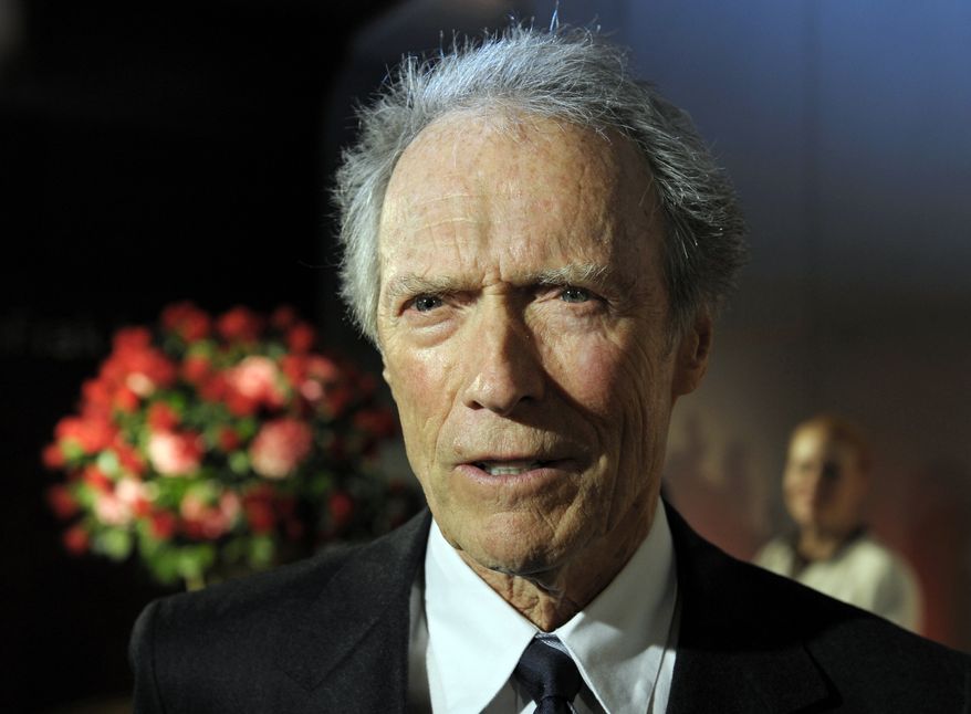 Actor and director Clint Eastwood speaks with reporters at the opening of the Warner Bros. Theater at the Smithsonian Institution's National Museum of American History in Washington on Wednesday, Feb. 1, 2012. (AP Photo/Cliff Owen)