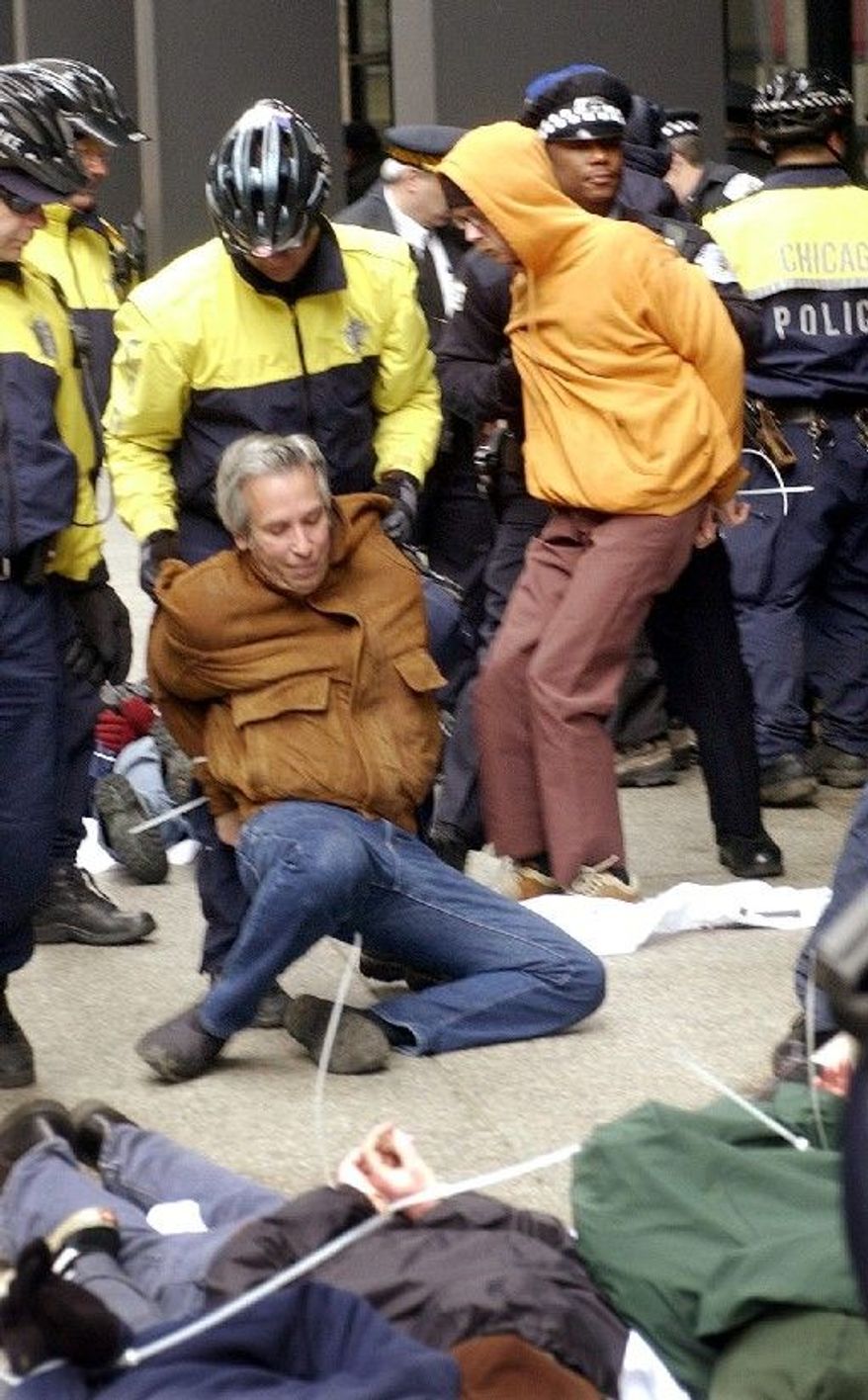 ASSOCIATED PRESS
Chicago police arrest activists during a 2003 anti-war demonstration. A city alderman is pushing an ordinance barring electronic-device blackouts by police at the May G-8 and NATO summits.