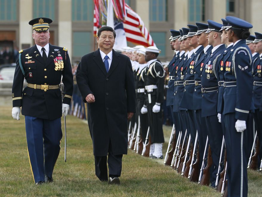 Chinese Vice President Xi Jinping reviews the troops during a full honors ceremony on Feb. 14, 2012, at the Pentagon in Arlington. (Associated Press)