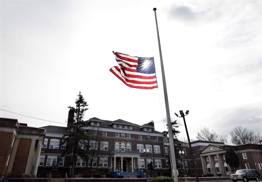 An American flag flies at half-staff in front of the Whitney E. Houston Academy of Creative and Performing Arts in East Orange, N.J., on Feb. 12, 2012. (Associated Press)