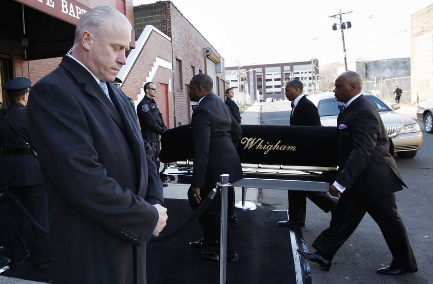 A coffin holding the remains of singer Whitney Houston is carried into the New Hope Baptist Church before her funeral services in Newark, N.J., on Saturday, Feb. 18, 2012. (AP Photo/Jason DeCrow)