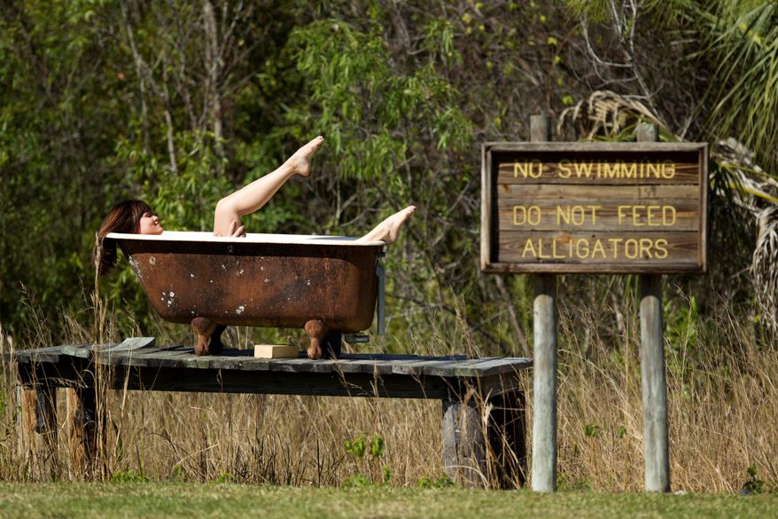 Allison Sparks poses in a bathtub during a photo shoot at Lucky's Place. (Associated Press)
