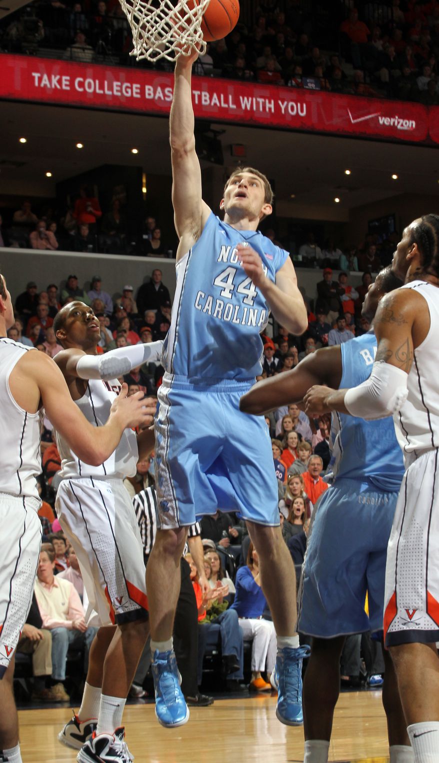 North Carolina forward Tyler Zeller shoots the ball next to Virginia forward Akil Mitchell during the first half on Saturday, Feb. 25, 2012, in Charlottesville, Va. (AP Photo/Andrew Shurtleff)