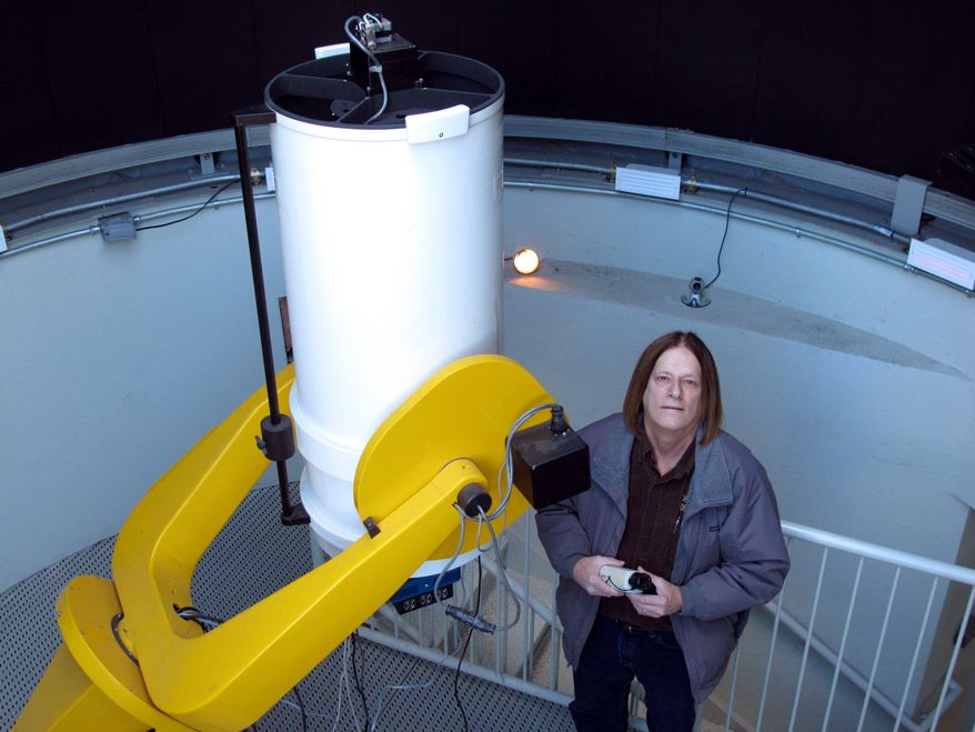 Astronomy professor Daniel Caton stands next to a low-light video camera at Appalachian State University in Boone, N.C. He hopes to use the cameras to capture a phenomenon known as the Brown Mountain Lights. (Associated Press)