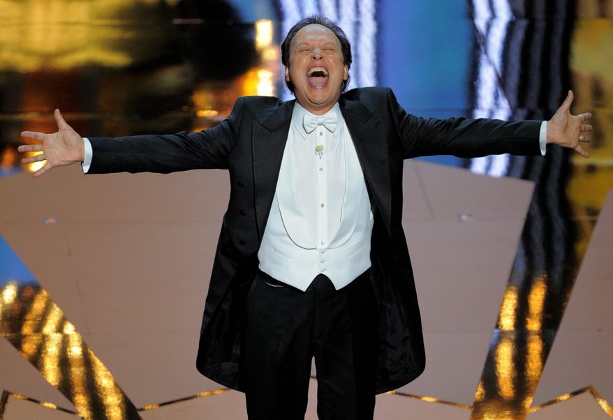 Critics panned Billy Crystal's hosting and the rest of Sunday's Academy Awards show, but ratings 4 percent higher than last year's indicate viewers didn't miss the "edge" critics wanted. (Associated Press)