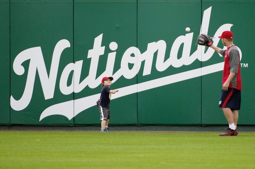 andrew harnik/the washington times
Nationals relief pitcher Sean Burnett plays catch with his son Sebastian, 3, on Thursday at Space Coast Stadium in Viera, Fla.