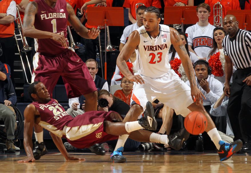 Florida State guard Michael Snaer draws an offensive foul from Virginia forward Mike Scott during the first half Thursday, March 1, 2012, in Charlottesville, Va. (AP Photo/Andrew Shurtleff)