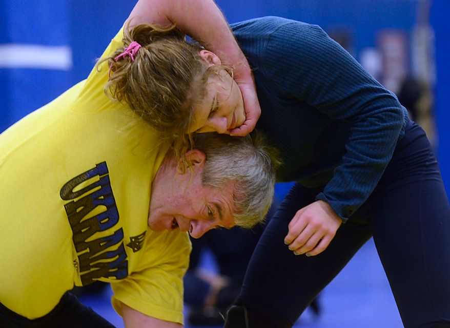 Helen Maroulis, a wrestler from Rockville, Md, may be the best U.S. wrestler in her weight class. She is currently training at the U.S. Olympic Training Center in Colorado Springs, Colo. She and other members of the U.S. team, as well as wrestlers from other countries, spent time training together, Thursday,Mar. 1, 2012. Wrestling coach Victor Kupchynsky shows Maroulis as professional wrestling move, the two-arms one leg move. (BryanOller/Special to the Washington Times)