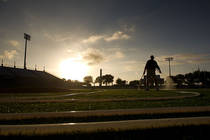 A member of the grounds crew waters the infield in the early morning hours before the Washington Nationals practice during spring training at Space Coast Stadium, Viera, Fla., Wednesday, Feb. 29, 2012. (Andrew Harnik/The Washington Times)
