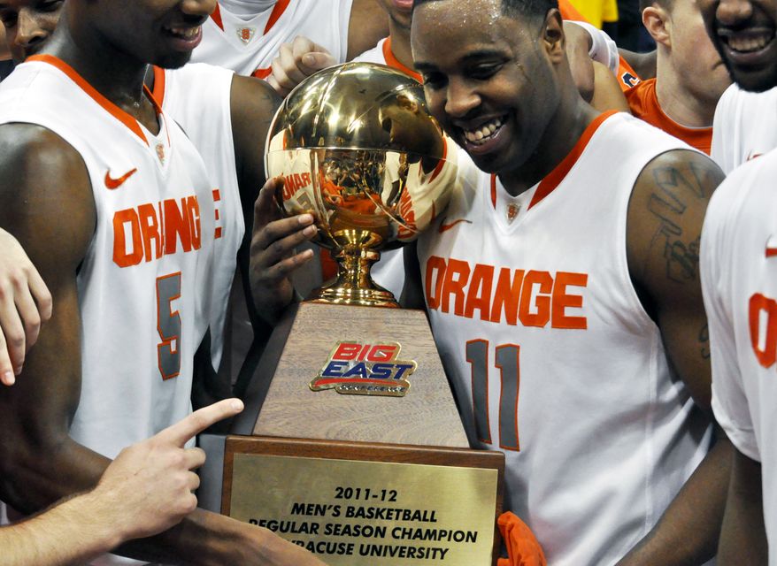 Syracuse's Scoop Jardine (11) and fellow teammates celebrate their regular-season championship after defeating Louisville 58-49 in Syracuse, N.Y., Saturday, March 3, 2012. (AP Photo/Kevin Rivoli)