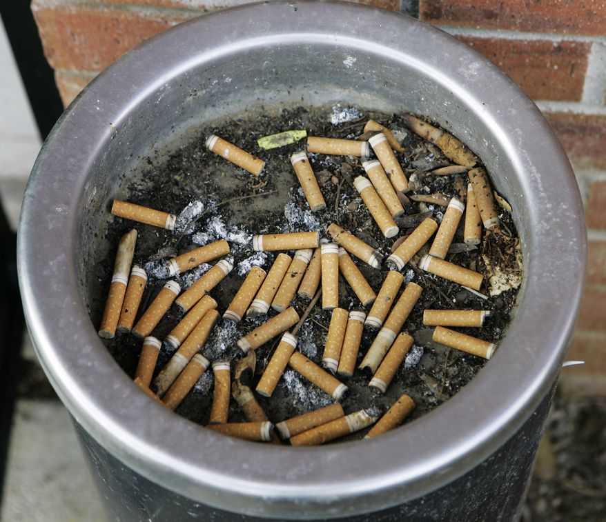 **FILE** An ashtray full of cigarette butts is shown in Omaha, Neb., on March 28, 2007. (Associated Press)