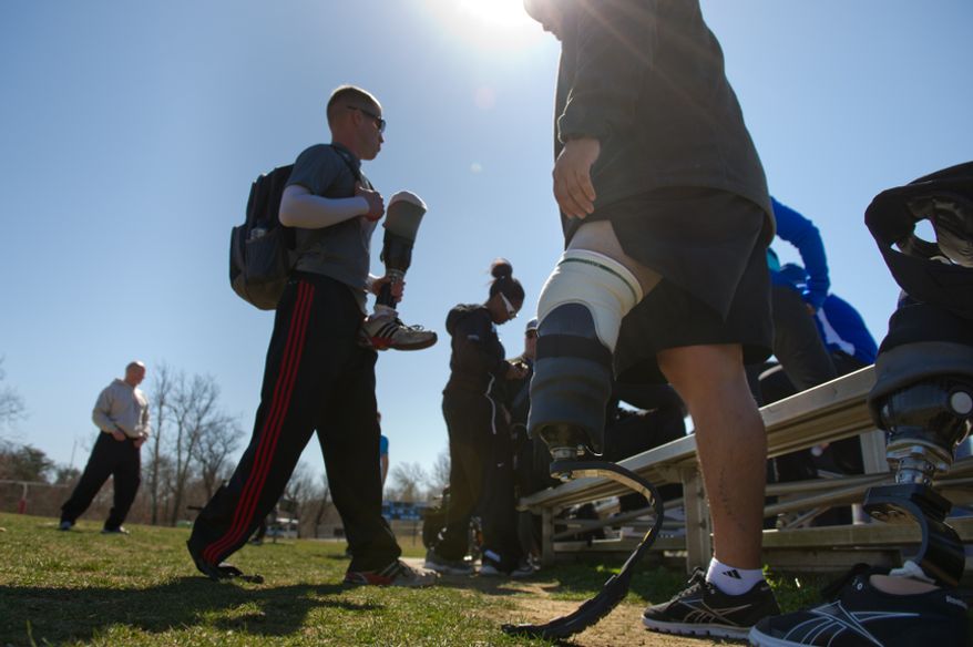 Spc. Brynden Keller of Indianapolis, Ind. who lost his leg outside of Kandahar Providence in Afghanistan, second from left, and Sgt. Julio Larrea of New York, N.Y., who lost his leg in 2010 from a vehicle rollover in Afghanistan get ready to compete in races with other wounded soldiers and Army veterans from across the United States in the Army Warrior Games clinics for a chance at a spot on the Army Warrior Games team, Fort Meade, Md., Sunday, March 11, 2012. The 2012 Warrior Games, held April 30th - May 5th in Colorado Springs, Colo., features representatives from Army, Navy, Air Force, Marines and Special Operations and will compete for gold metals in archery, cycling, wheelchair basketball, shooting, swimming, track and field, and sitting volleyball. (Andrew Harnik/The Washington Times)