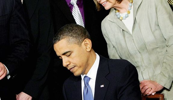 House Speaker Nancy Pelosi was one of the dignitaries on hand as President Obama signed the Affordable Care Act on March 23, 2010. The Supreme Court will start hearing arguments on the law's insurance mandate on March 26. (Associated Press)