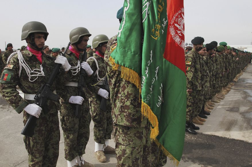 Afghan soldiers take positions during a graduation ceremony at a military training center in Kabul, Afghanistan, on March 14, 2012. (Associated Press)