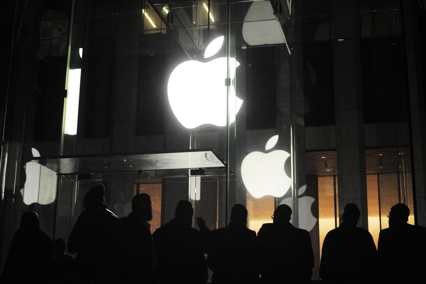 ** FILE ** People gather March 16, 2012, outside an Apple retail store on Fifth Avenue in the Manhattan borough of New York as they wait for the 8 a.m. release of the new iPad tablet. (Associated Press)