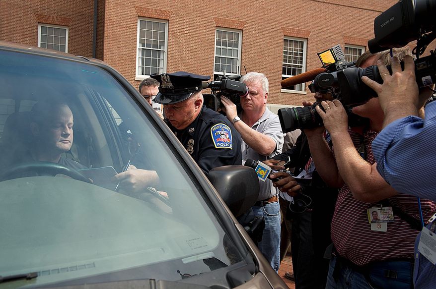 Capitol Police Officer Thomas Crewe gives Carl Garrett of Millersville, Md., a ticket for illegal use of his horn during the protest. The fine is $60. (Barbara L. Salisbury/The Washington Times)