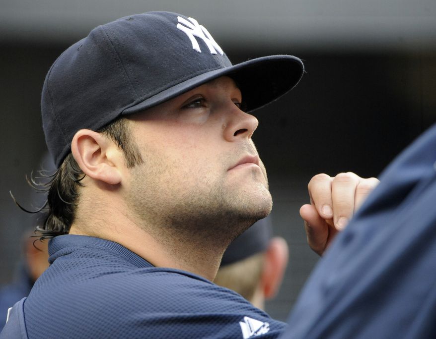 FILE - In this June 13, 2011 photo, New York Yankees pitcher Joba Chamberlain looks on from the dugout during a baseball game against the Cleveland Indians at Yankee Stadium in New York. New York Yankees General manager Brian Cashman said Friday, March 23, 2012, that Chamberlain had surgery Thursday night and will be hospitalized for at least a few days. Cashman says the accident happened Thursday afternoon while Chamberlain and his son were at a Tampa-area spot that has trampoline equipment. The team is not saying whether Chamberlain was using any of the equipment. (AP Photo/Bill Kostroun)