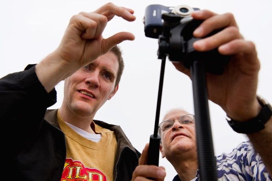 Staff member Rene Gonzales (right) helps Matt take photographs before Matt returned to the computer lab at the Community Services for Autistic Adults and Children in Montgomery Village for editing. (Andrew Harnik/The Washington Times)