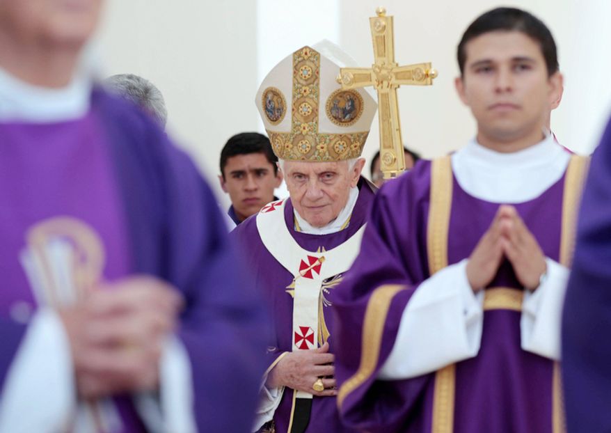 Pope Benedict XVI walks with his pastoral staff prior to the start of Sunday Mass in Bicentennial Park. (AP Photo/Gregorio Borgia)