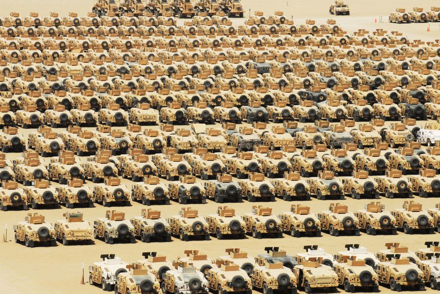A collection of vehicles built to resist mine blasts and protect occupants from ambush are parked in a holding yard at Camp Arifjan, Kuwait, awaiting shipment. (Army photograph)