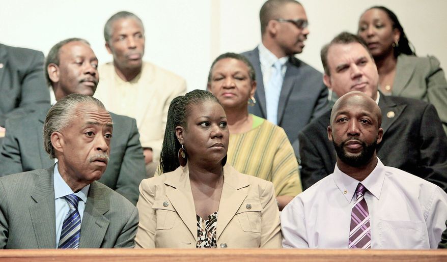 Sybrina Fulton and Tracy Martin, the parents of Trayvon Martin, sit with the Rev. Al Sharpton (left) during a community forum on in the aftermath of his killing by George Zimmerman.