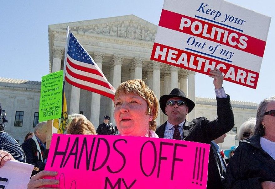 **FILE** Kathy Hansen, a family practice doctor in Houston, protests President Obama's health care law outside the Supreme Court on March 27, 2012. The justices were listening to arguments on the law's individual mandate. (The Washington Times)