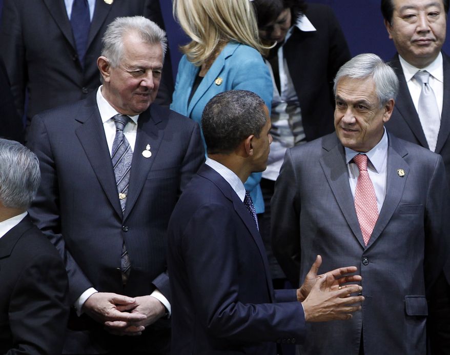 President Obama (center) speaks to Chilean President Sebastian Pinera (right) on March 27, 2012, prior to a group photo session at the Nuclear Security Summit in Seoul. (Associated Press)