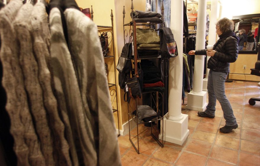 **FILE** Laurie Hanson looks over clothing Feb. 28, 2012, at the Adorn clothing store in Montpelier, Vt. (Associated Press)