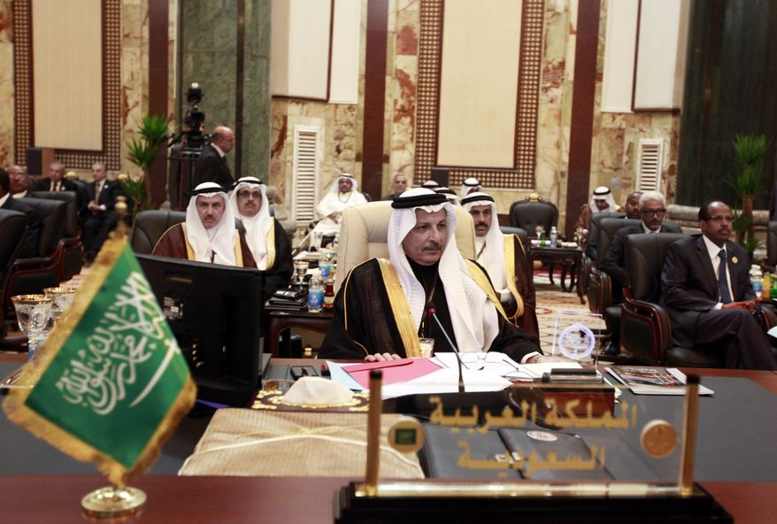 Ahmad al-Qattan (center), Saudi Arabia's permanent representative to the League of Arab States, attends the annual Arab League summit in Baghdad on March, 29, 2012. (Associated Press)
