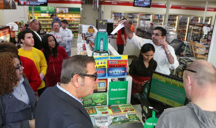 Kinju Patel and her husband, Kinjal Patel, owners of the 7-11 store in Northfield, N.J., sell lottery tickets for Mega Millions as a line forms in the store Friday, March 30, 2012. (AP Photo/The Press of Atlantic City, Vernon Ogrodnek)
