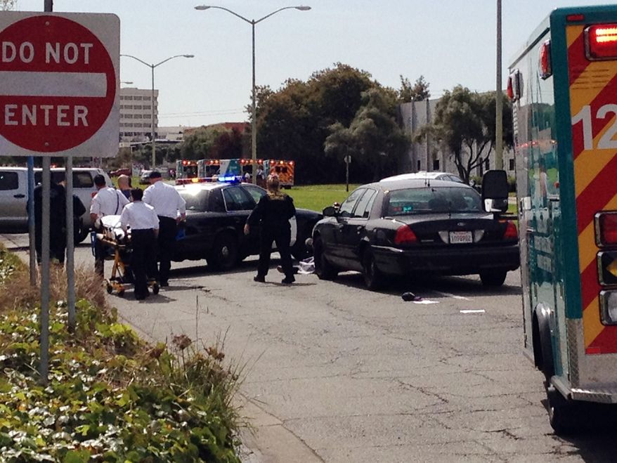 Police surround the Oikos University campus in Oakland, Calif., on Monday, April 2, 2012, in search of a gunman who reportedly opened fire, killing at least five people, authorities said. (AP Photo/San Francisco Chronicle, Demian Bulwa)