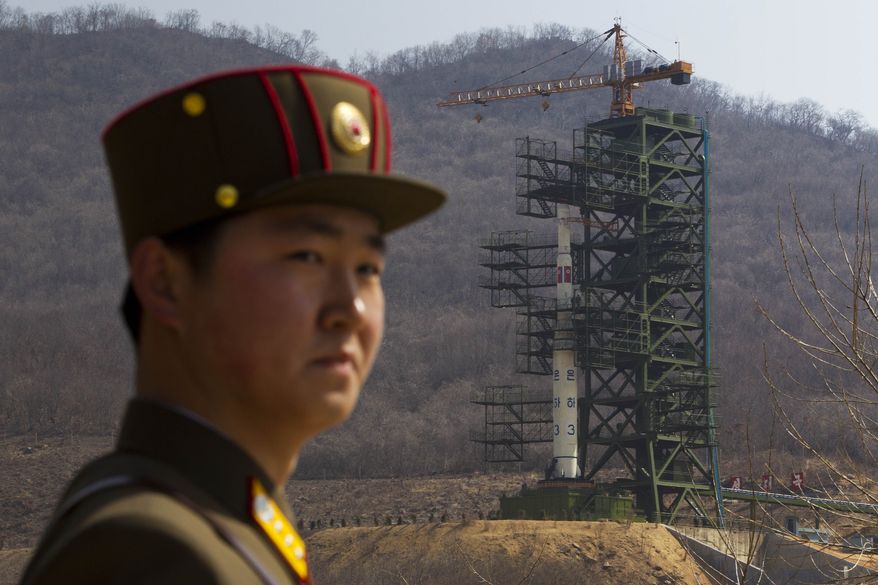 ** FILE ** A North Korean soldier stands in front of the country's Unha-3 rocket, which was launched unsuccessfully on Friday, April 13, 2012. (AP Photo/David Guttenfelder)