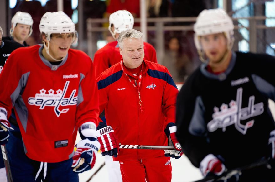 Capitals coach Dale Hunter (center) shares a light moment with captain Alex Ovechkin (left) during practice Tuesday. The Caps are hoping their recent road success continues Thursday against Boston. (Andrew Harnik/The Washington Times)