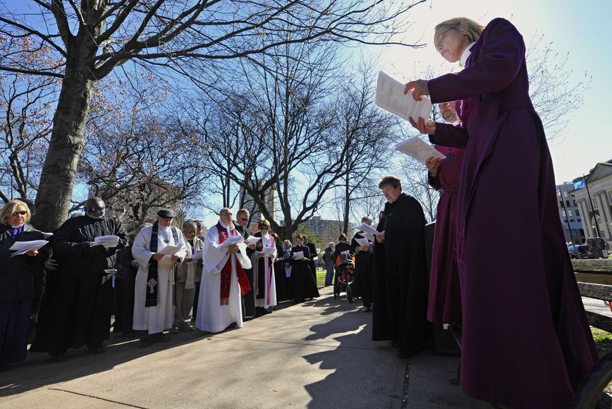 **FILE** Connecticut religious leaders who oppose the death penalty stop for a prayer during an April 3, 2012, march in Hartford, Conn., to the state Capitol for a rally in favor of repealing the punishment at state level. (Associated Press)