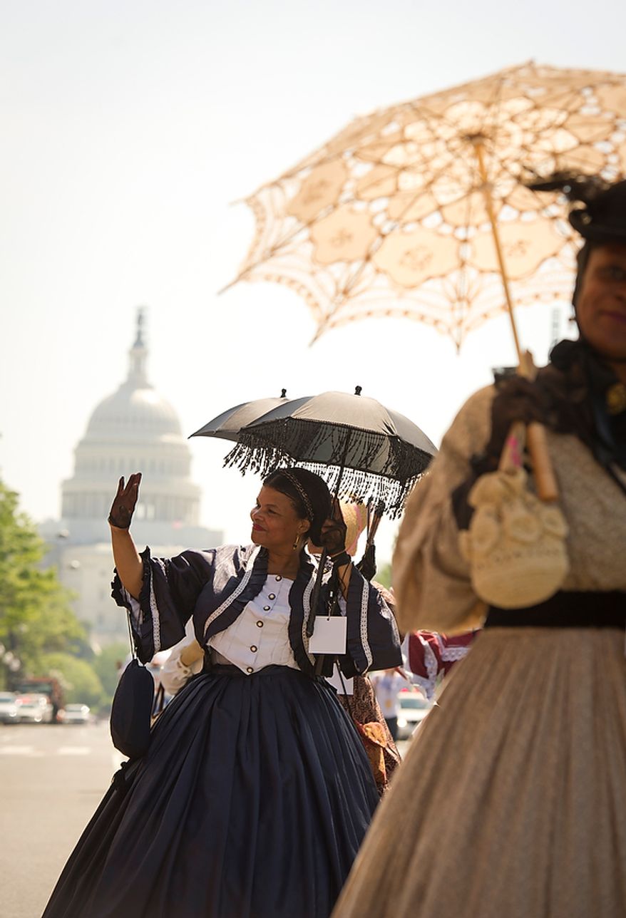 Members of the Women of the American Civil War, from Orange County, Va., Lillian Garland, portraying the part of Elizabeth Keckley (left) and Denise Benedetto, portraying the part of Mary Elizabeth Bowser (right) wave to the crowd as they march in the District of Columbia Emancipation Day 2012 parade in Washington, D.C., Monday, April 16, 2012., celebrating the150th anniversary of the District of Columbia Emancipation Act. 150 ears ago, on April 16, 1862, President Abraham Lincoln signed a bill ending slavery in the District of Columbia. Passage of this law came 8 1/2 months before President Lincoln signed his Emancipation Proclamation. (Rod Lamkey Jr/The Washington Times)