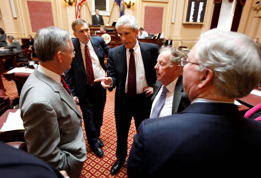 Senate Minority Leader Richard L. Saslaw (center), Fairfax Democrat, talks with Senate Majority Leader Thomas K. Norment Jr. (left), James City Republican, as Sen. Emmett Hanger (second from left), Augusta Republican, and Sen. Charles Colgen (second from right), Prince William Democrat, and Finance Committee Chairman Sen. Walter Stosch, Henrico Republican, listen prior to the debate on the budget conferees' report at the Capitol in Richmond on Tuesday. (Associated Press)