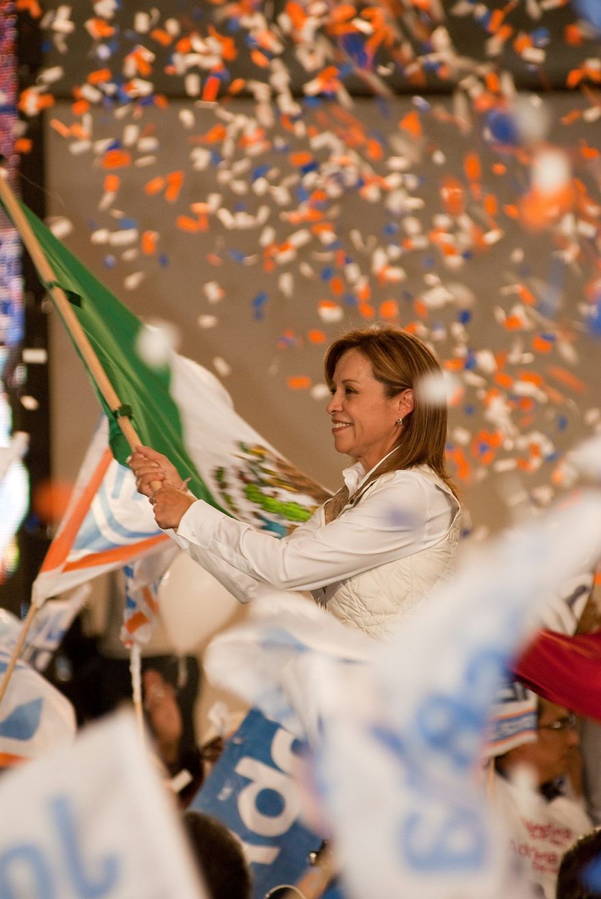 Josefina Vasquez Mota waves a Mexican flag at a rally last week in her campaign to win the presidency. (Keith Dannemiller/Special to The Washington Times)