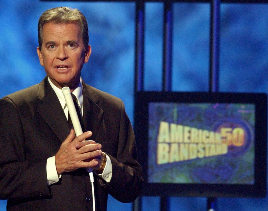 **FILE** Dick Clark, host of the American Bandstand television show, introduces entertainer Michael Jackson on stage April 20, 2002, during taping of the show's 50th anniversary special in Pasadena, Calif. (Associated Press)