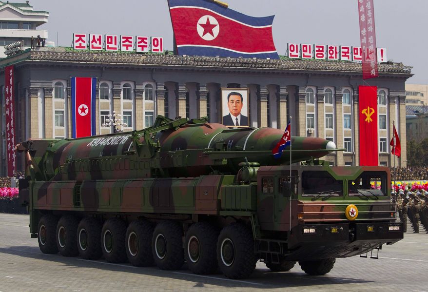 ** FILE ** In this April 15, 2012, file photo, a North Korean vehicle carrying a missile passes by during a mass military parade in Pyongyang's Kim Il Sung Square to celebrate the centenary of the birth of the late North Korean founder Kim Il Sung. The enormous, 16-wheel truck used to carry the missile, likely came from China in a possible violation of U.N. sanctions meant to rein in Pyongyang's missile program, experts say. (AP Photo/David Guttenfelder, File)