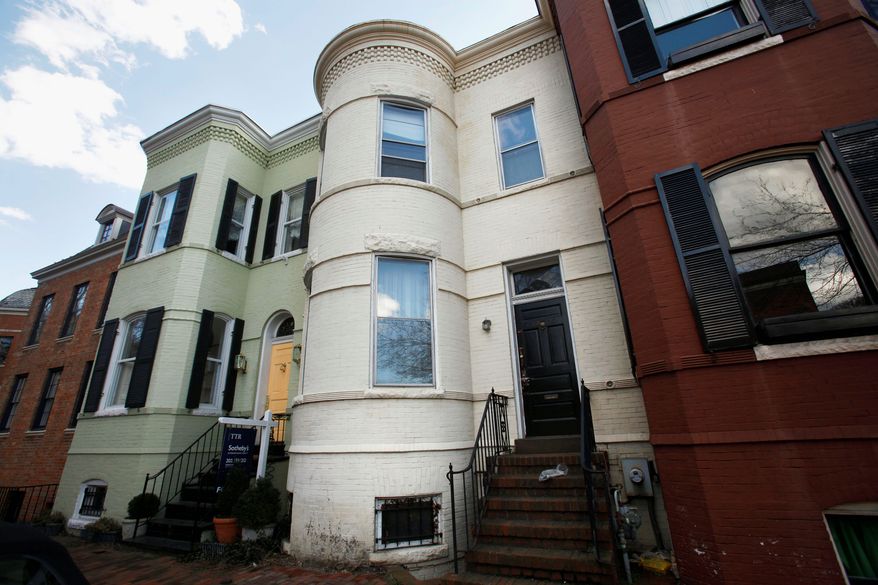 This row house in Georgetown was home to Albrecht Muth, 47, and Viola Drath, 91. Mr. Muth, charged with killing his socialite wife, faces a competency hearing Wednesday. (Associated Press)