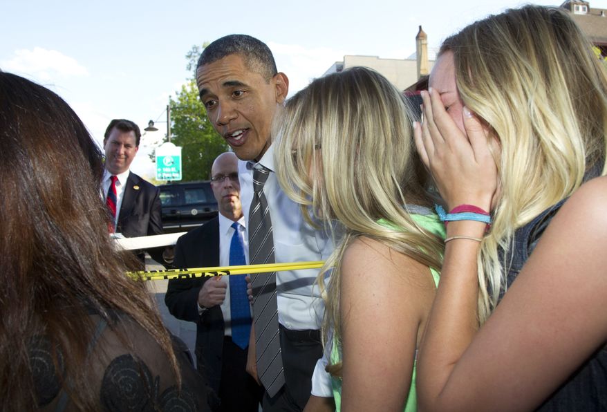 President Obama reacts to having frozen yogurt spilled on his pants as he was greeting the crowd outside the Sink restaurant on Tuesday, April 24, 2012, in Boulder, Colo. (AP Photo/Carolyn Kaster)