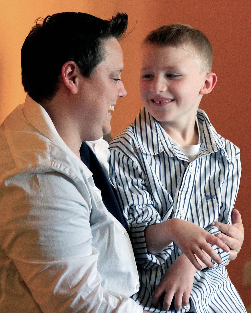 Jennifer Tyrrell, of Bridgeport, Ohio, seen here with son Cruz Burns, 7, was removed as leader of his Scout troop because of her sexual orientation. (Associated Press)